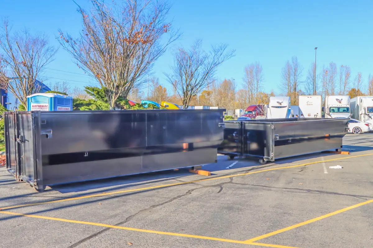 Professional dumpster rental service with roll-off container on residential driveway in Martic